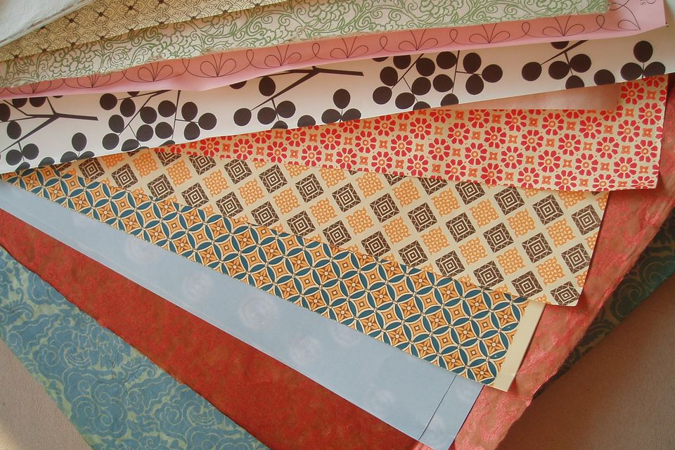 Fanned sheets of patterned coloured paper
