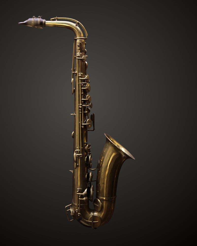 An alto saxophone against a dark grey background