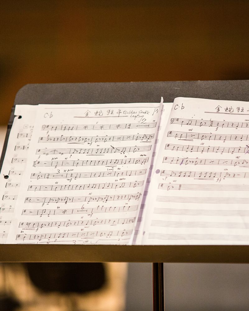 An open score on a music stand in warm light