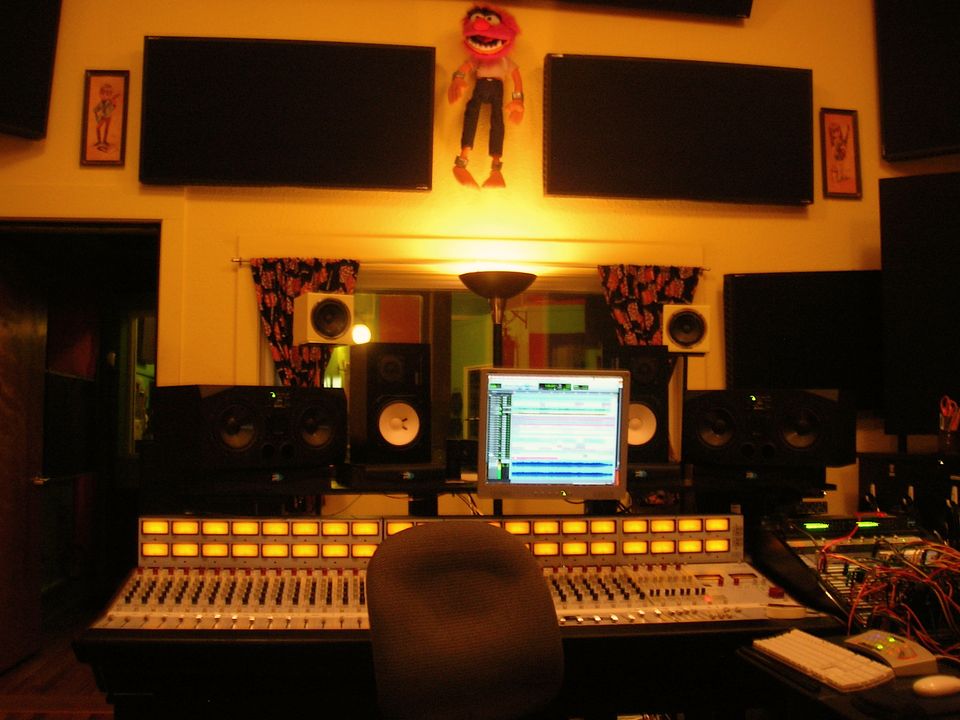 A recording studio control room with a mixing desk