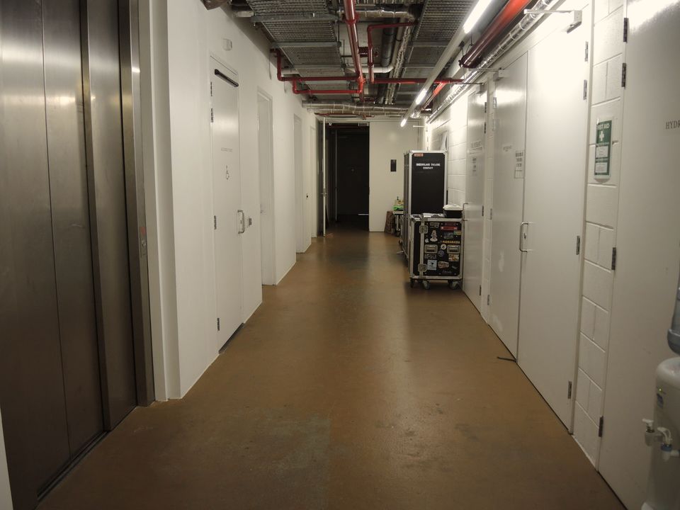 A quiet backstage corridor in a theatre