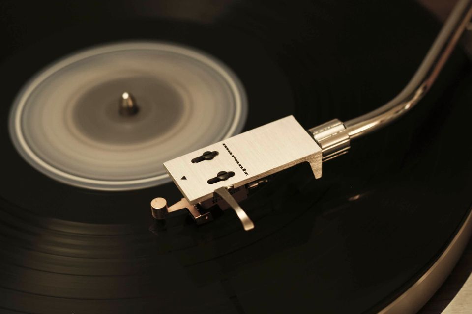 Close-up of a turntable headshell and needle on a record