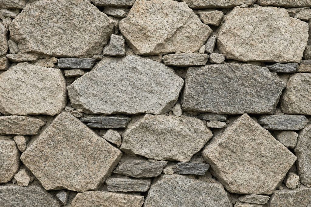 Close view of a dry-stacked fieldstone wall in even daylight