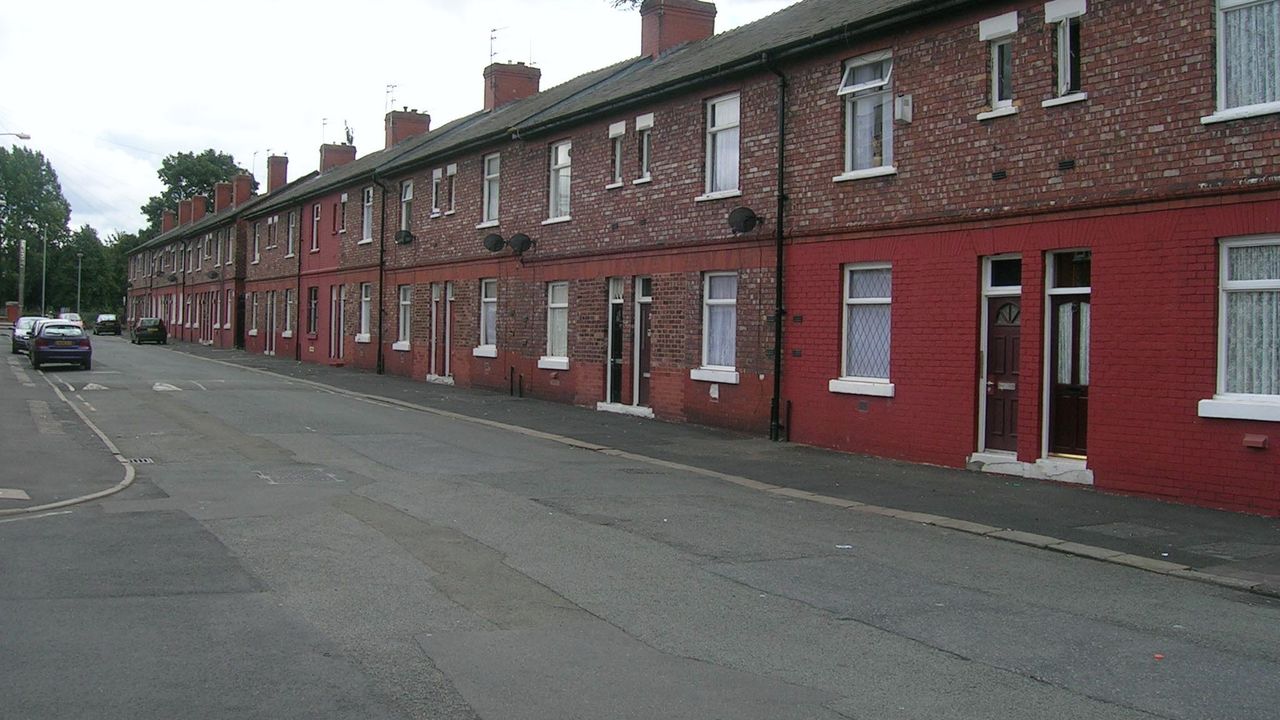 A row of red-brick terraced houses on Barrack Street, Hulme, Manchester