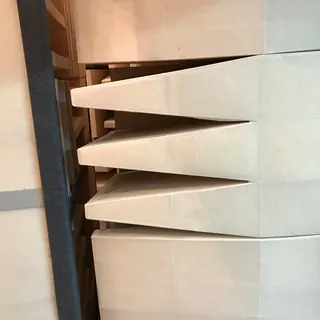 Pale foam wedges lining the wall of an anechoic chamber