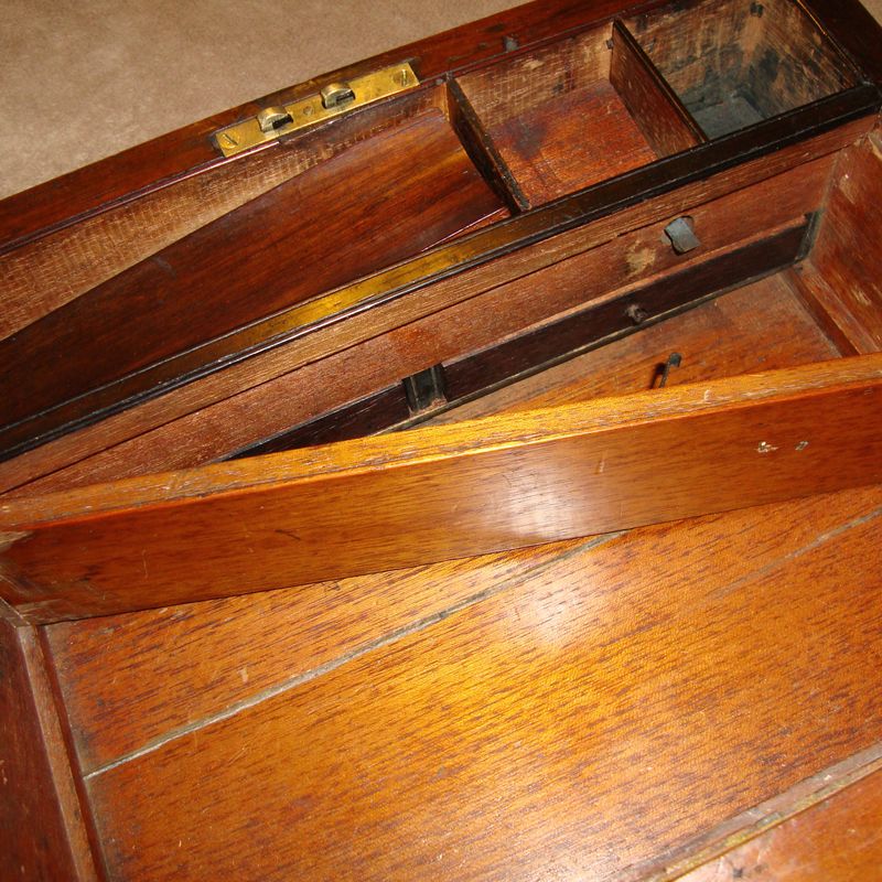 An antique wooden writing slope, opened