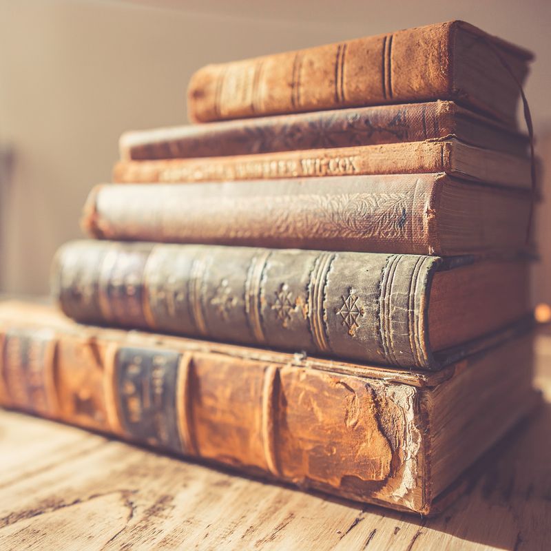 A small stack of old leather-bound books