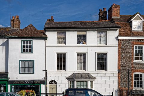Georgian high street with white-painted shopfronts and brick townhouses