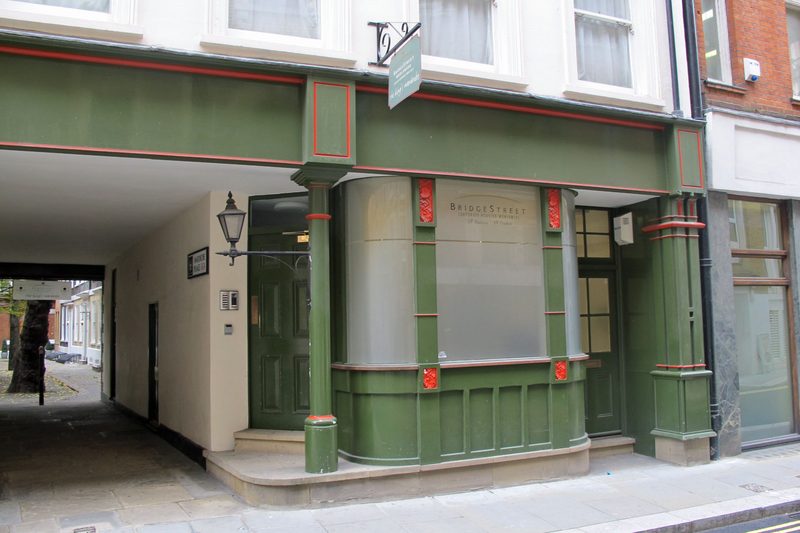 Georgian shopfront with green-painted timber, columns and a small-paned window