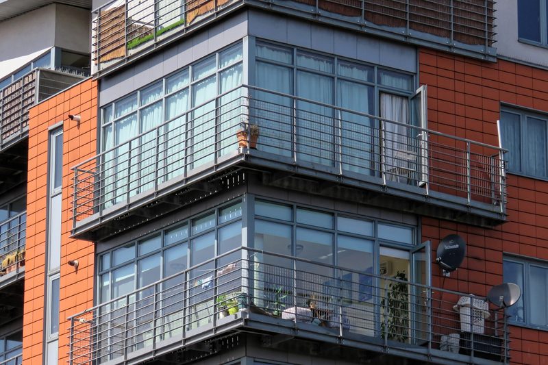Block of flats in red brick with glazed corner balconies