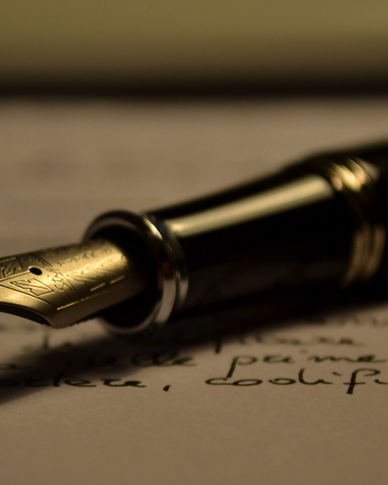 A fountain pen lying on a handwritten page