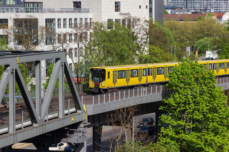 A yellow U-Bahn train on the elevated line by the German Museum of Technology in Kreuzberg, Berlin