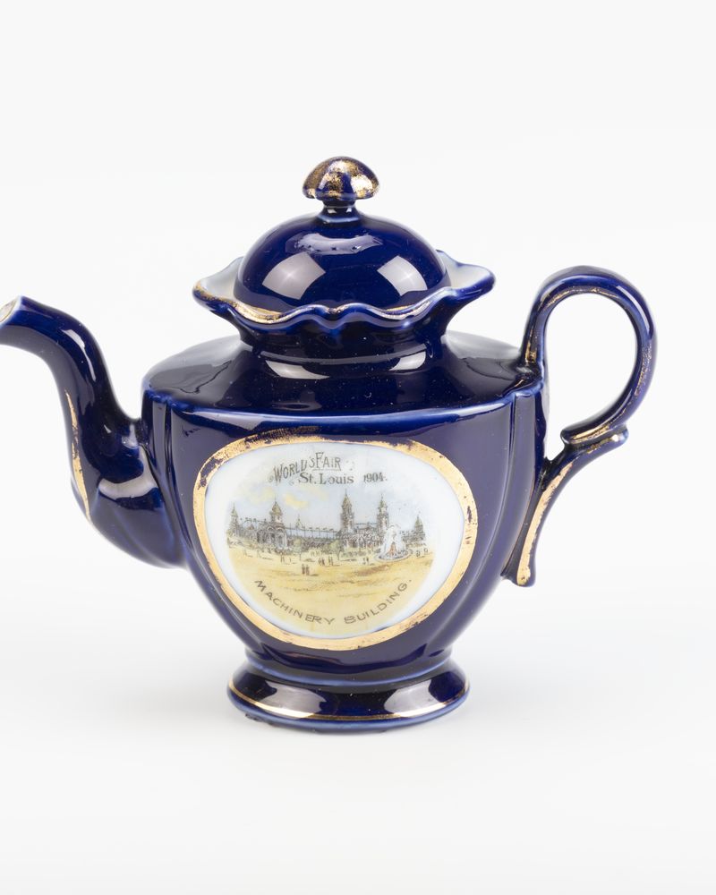 A small cobalt-blue teapot from an antique child's tea set