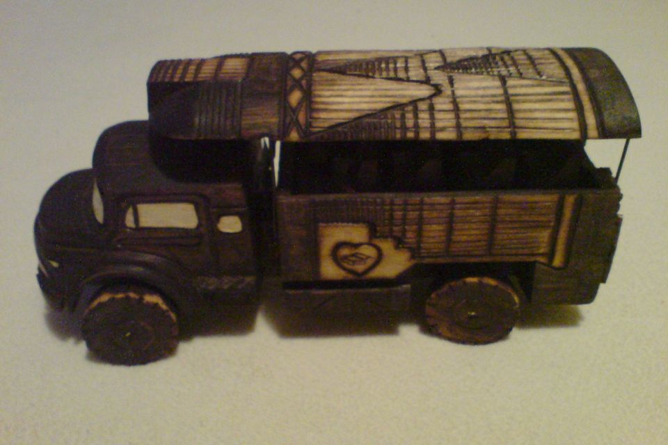 A carved wooden toy lorry