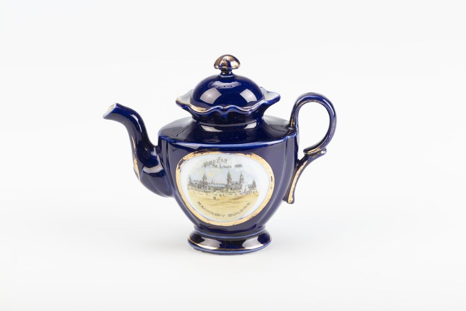 A small cobalt-blue teapot from an antique child's tea set