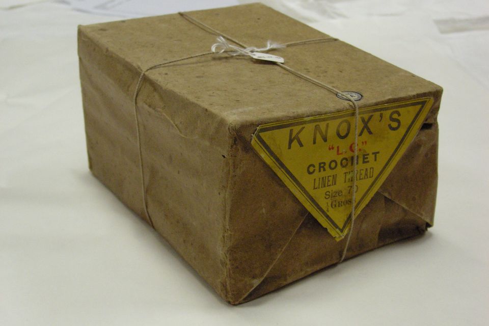 A small box wrapped in brown paper and tied with string