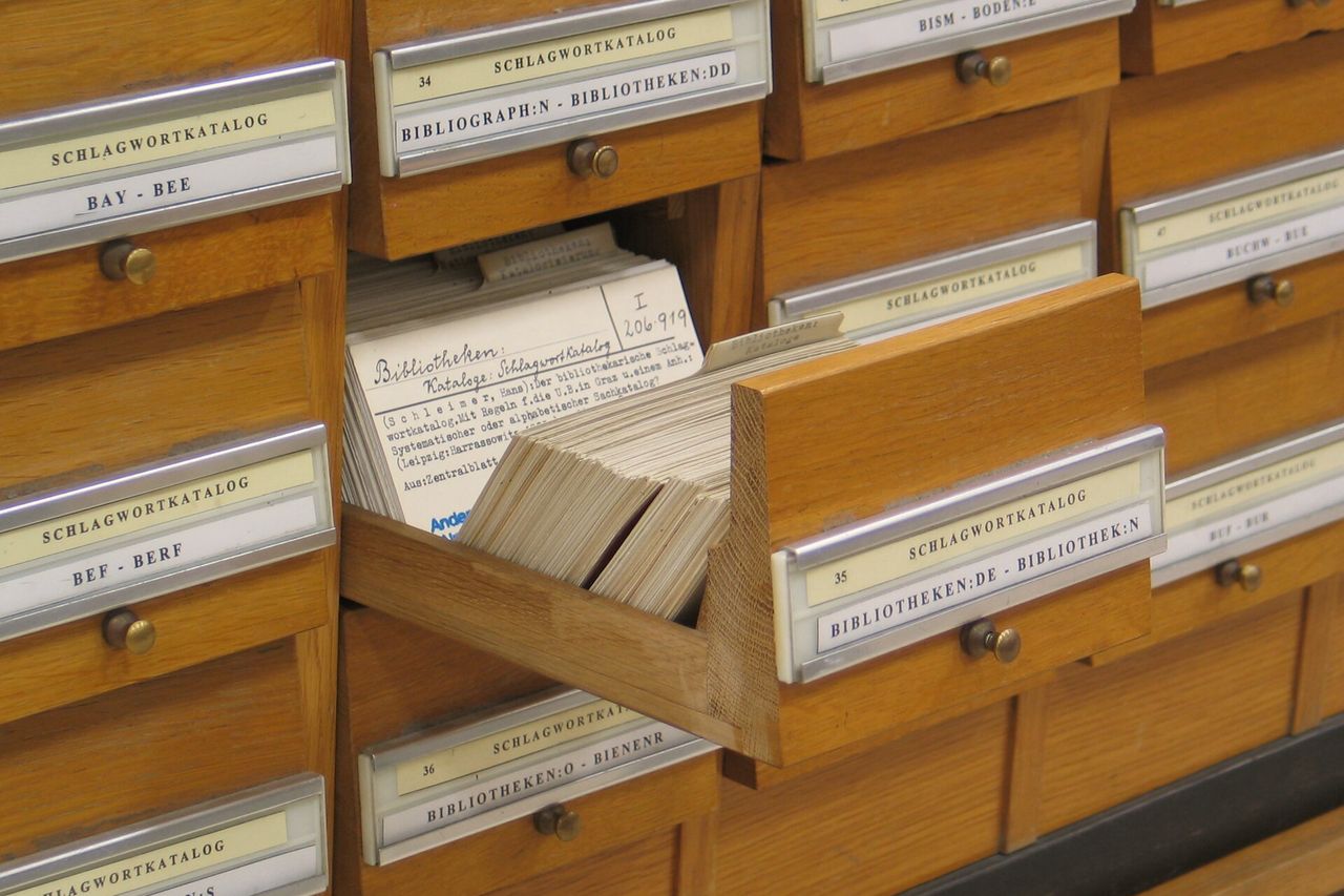 A library card catalogue with one drawer pulled out