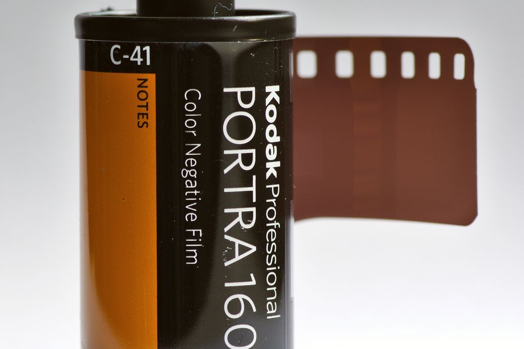 A roll of Kodak Portra colour negative film with its leader pulled out