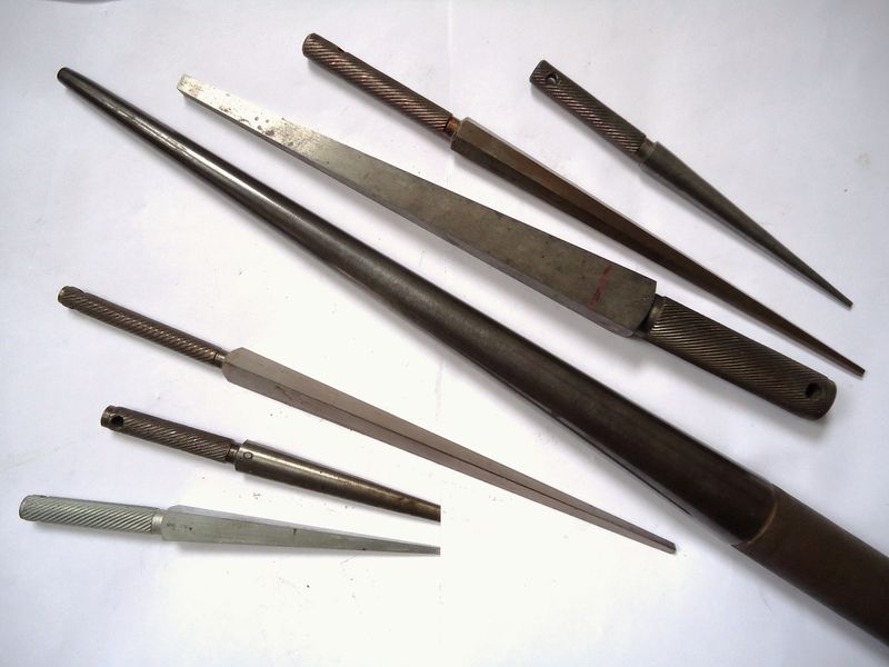 A row of fine needle files on a wooden worktop