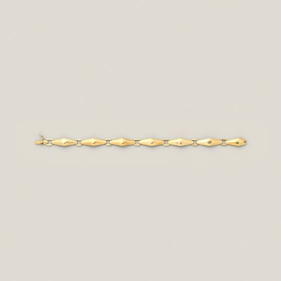 A fine gold link bracelet with diamond-shaped links, laid straight on pale grey, library photograph shown for style