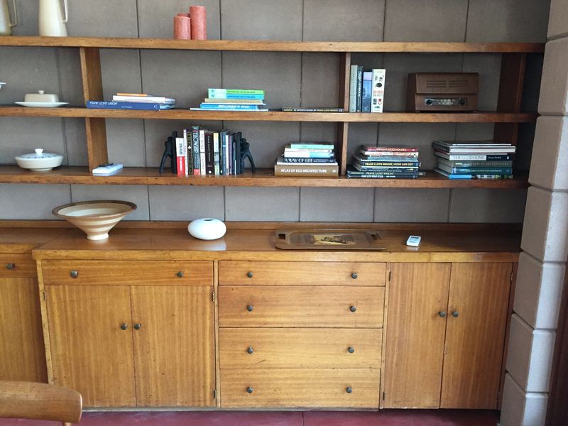 A run of built-in timber cabinets and drawers with open shelves above