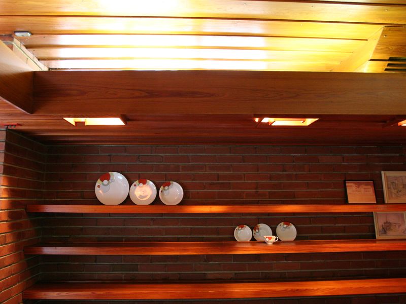 Long timber shelves set into a warm wood-lined wall