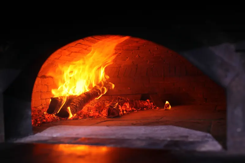 Flames inside a brick wood-fired oven
