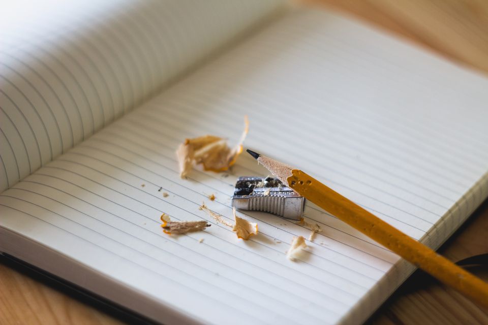 Pencil shavings and a pencil on a lined notebook