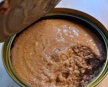 Close view of smooth wet cat food in an open tin
