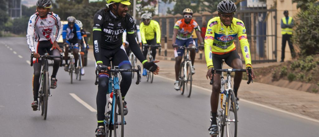 A group of cyclists riding together on a city road