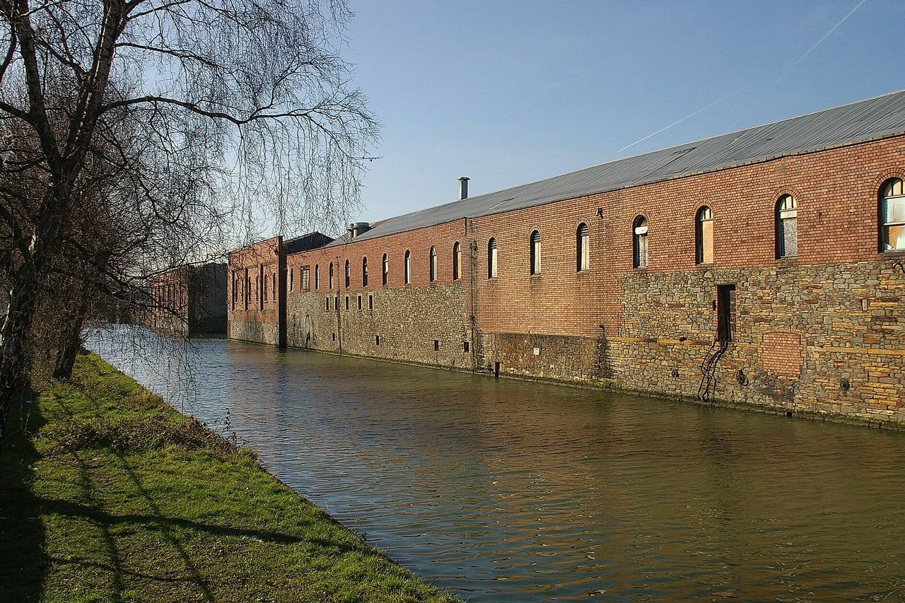 A brick warehouse beside the Feeder Canal in Bristol on a clear day