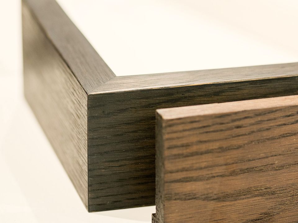 Two dark wooden frame mouldings, mitred at the corner
