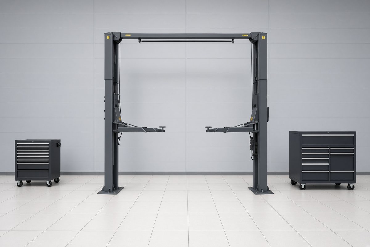 An empty service bay with a raised ramp and closed tool chests