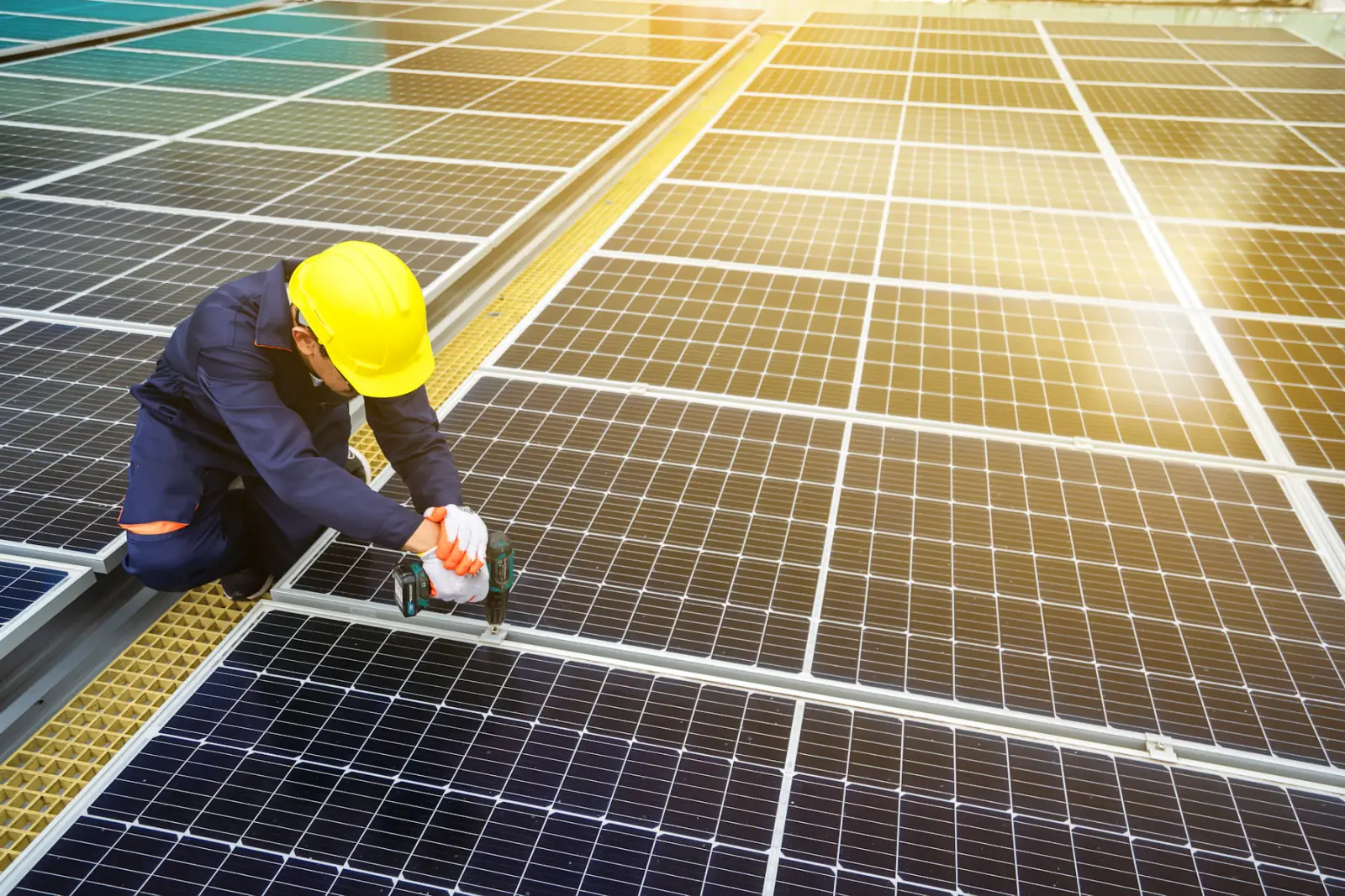An installer fixing solar panels to a roof frame