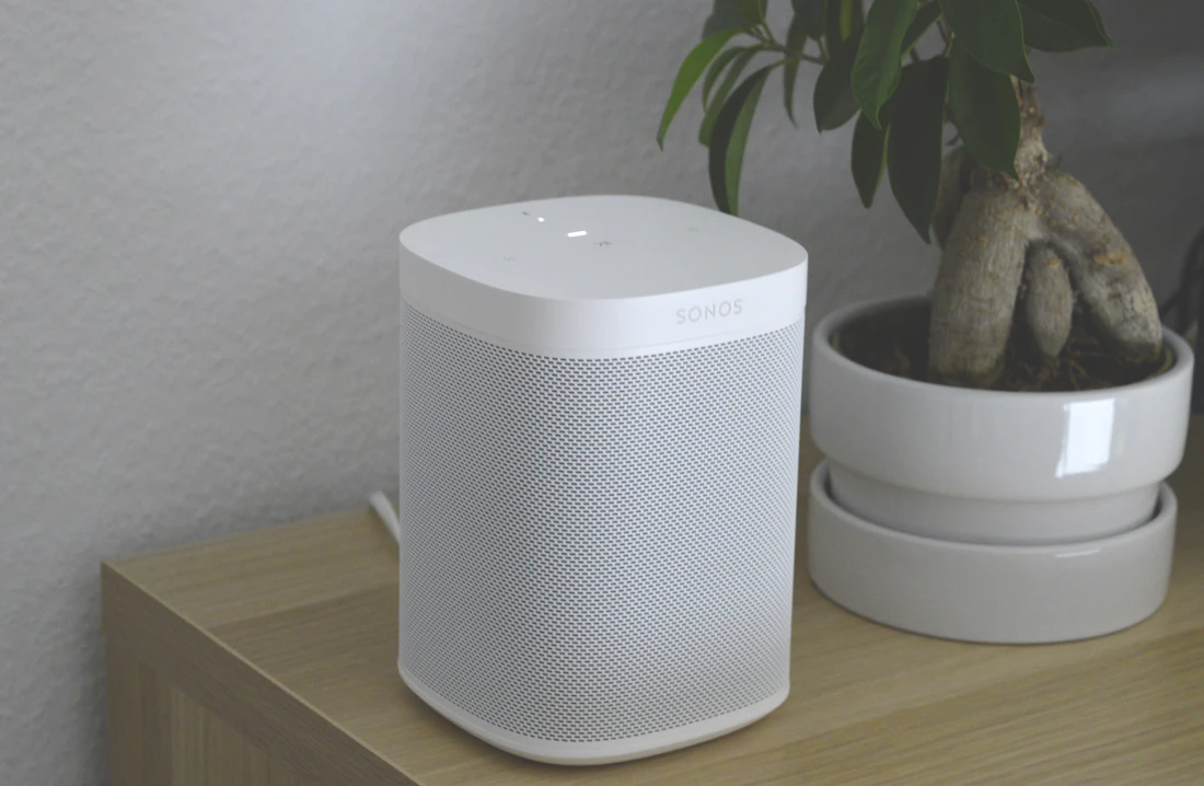 A white speaker on a side table